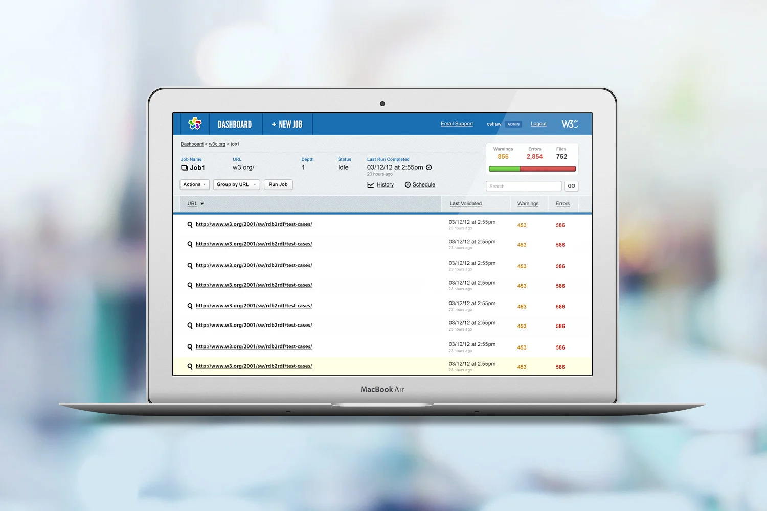 Finished W3C Validator Suite job interface shown on a laptop